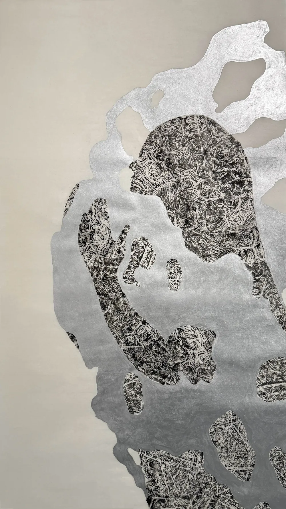Hug: a large silvered paper form enclosing a dark rubbing