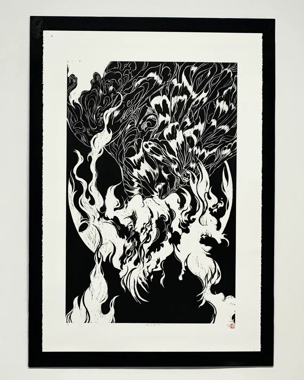 Once in a life time: a framed black-and-white relief print of a figure wreathed in flame