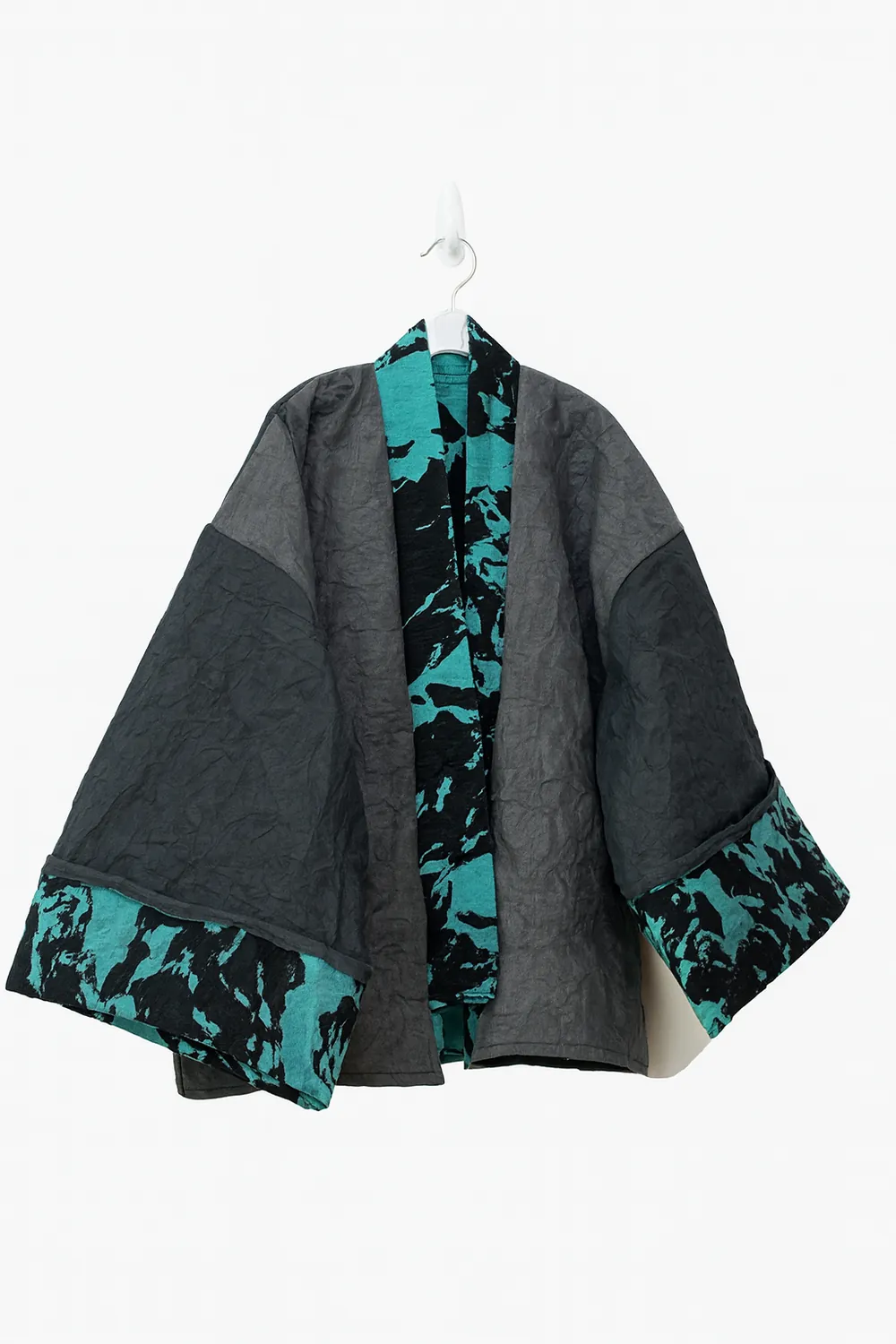 The screen-printed paper garment on a hanger